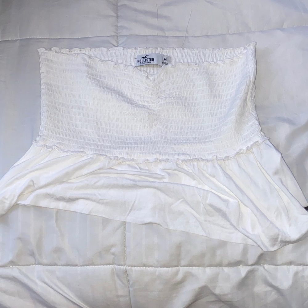 White crop top with frilly thing on the bottom